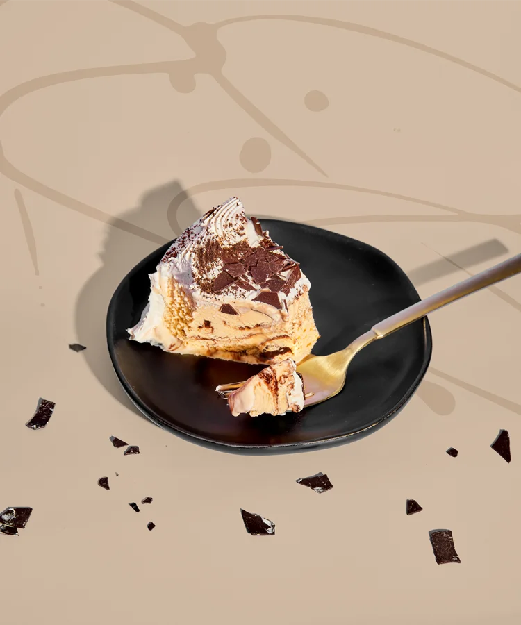 Hand with fork and ice cream cake