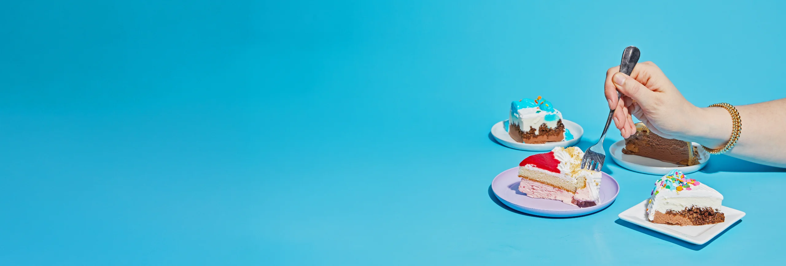 hand-with-fork-in-ice-cream-cake